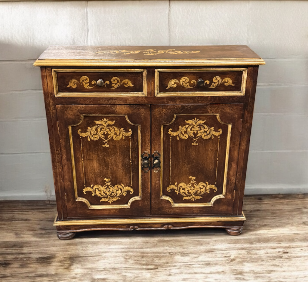 handpainted small brown cabinet with 2 doors, with scrolls in gold accents