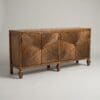 Wooden mid-century cabinet with sunburst veneer doors and small round knobs against a pale wall.