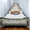 Ornate rustic bed with reverse painted glass on the edges of the headboard and the footboard, off white cream color